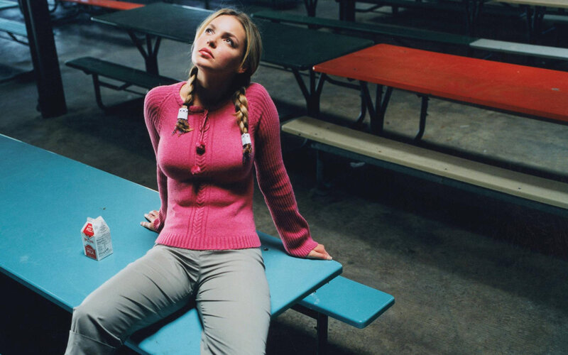 Woman in pink sweater at table