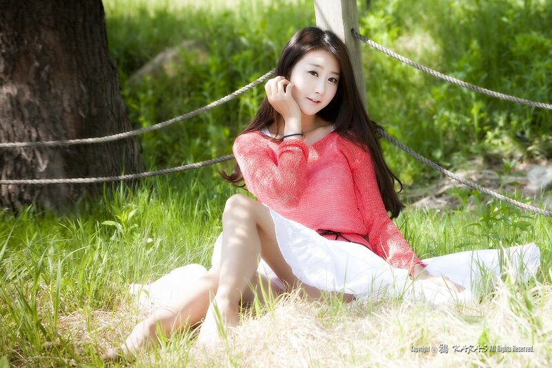Woman in pink sweater on grass
