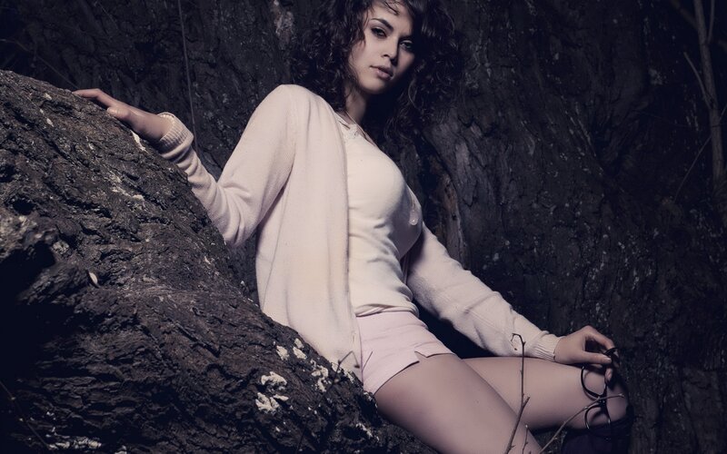 woman in pink sweater on rock