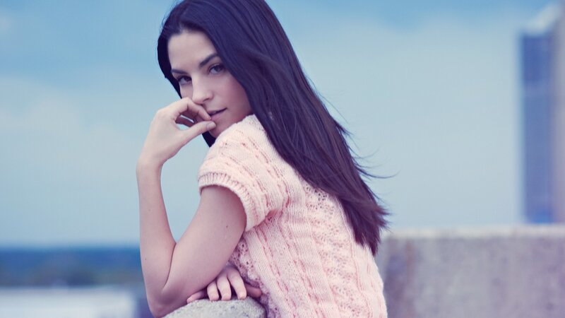 woman in pink sweater outdoors