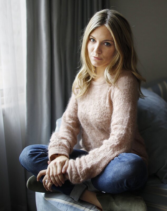 woman in pink sweater sitting