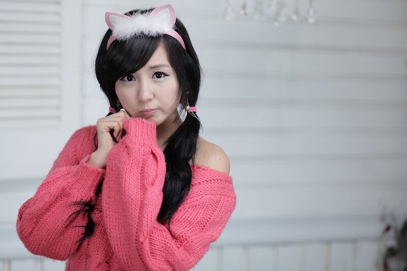 woman in pink sweater with cat ears