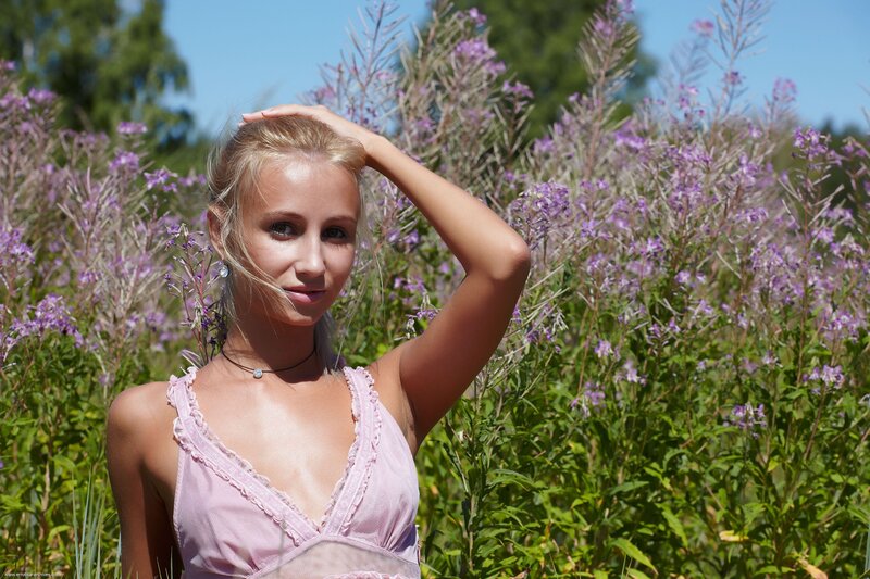 Woman in pink top among purple flowers