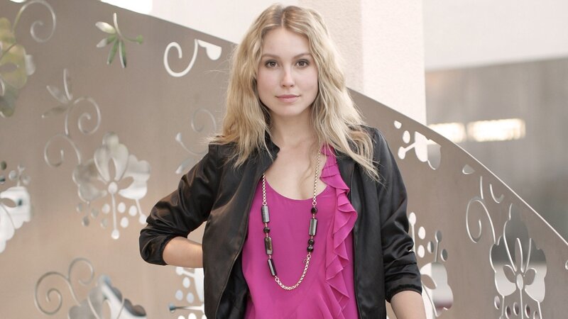 woman in pink top and black jacket