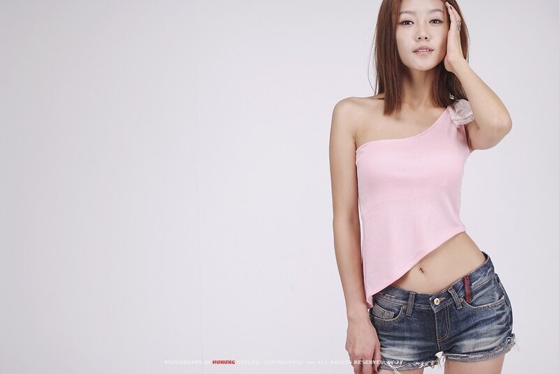 woman in pink top and denim shorts