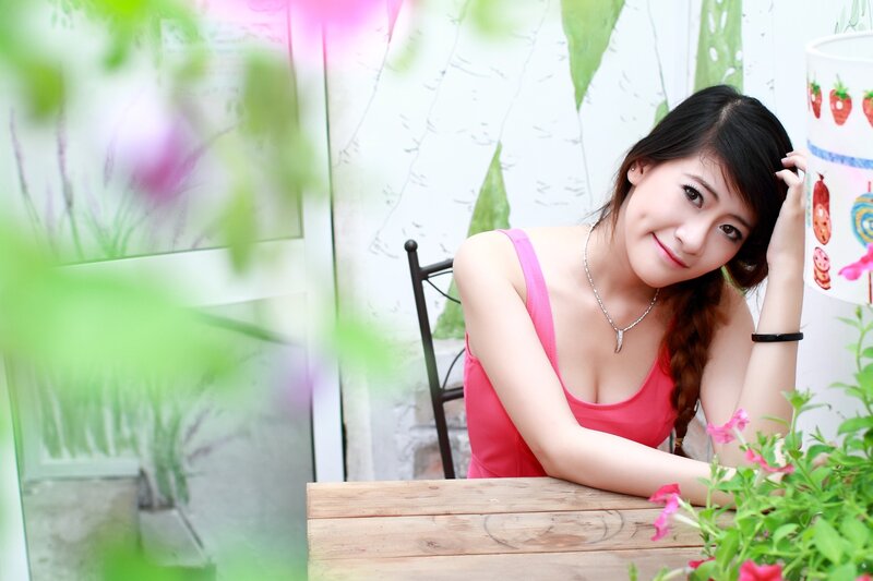 woman in pink top at table