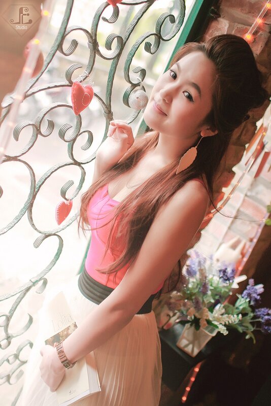woman in pink top by window