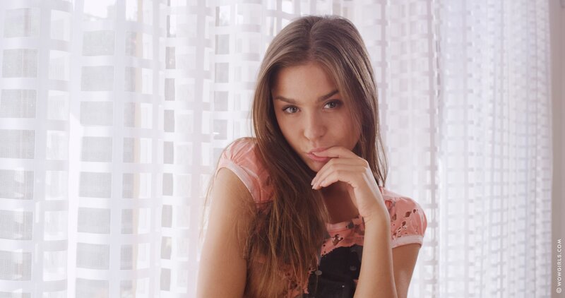 woman in pink top by window