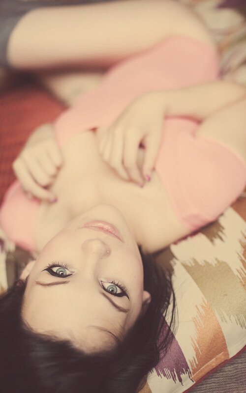 woman in pink top lying down