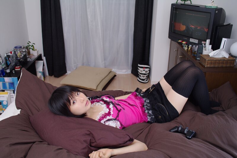 woman in pink top lying on bed