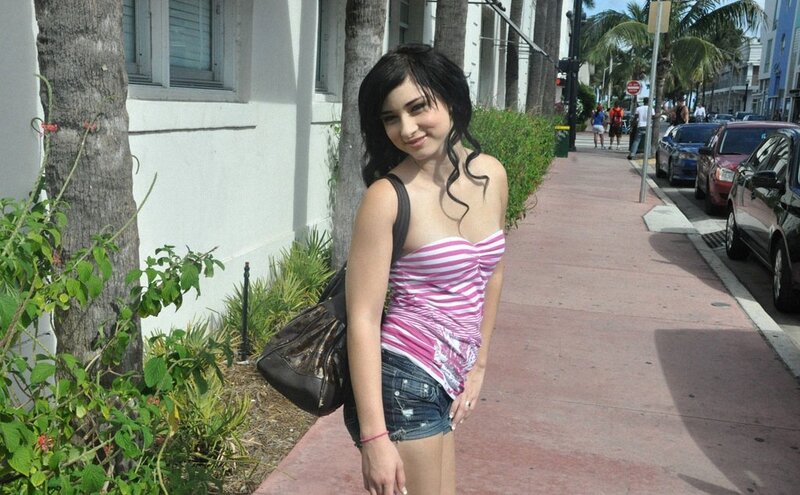 woman in pink top on sidewalk