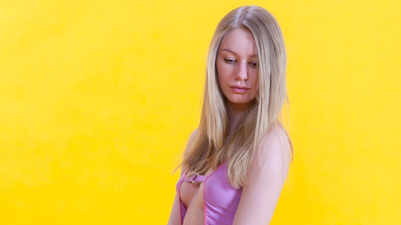 woman in pink top on yellow