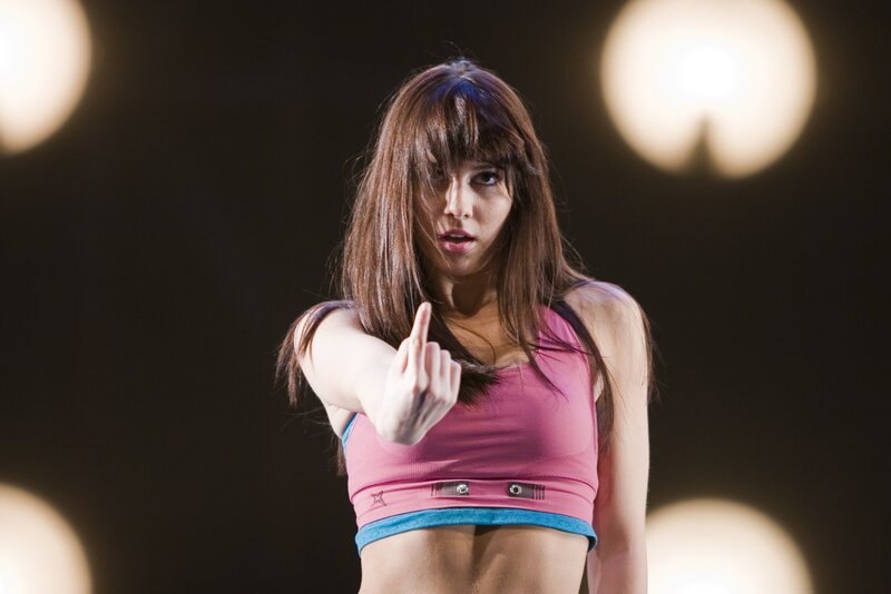woman in pink top pointing finger