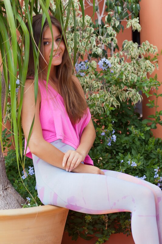 woman in pink top sitting outdoors