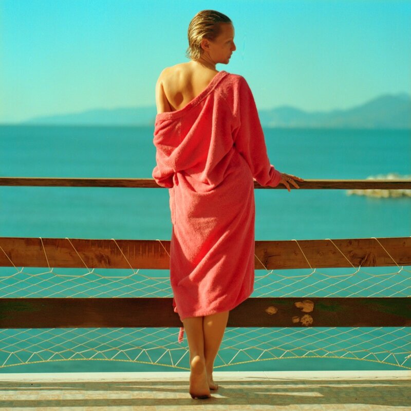 Woman in pink towel by the sea