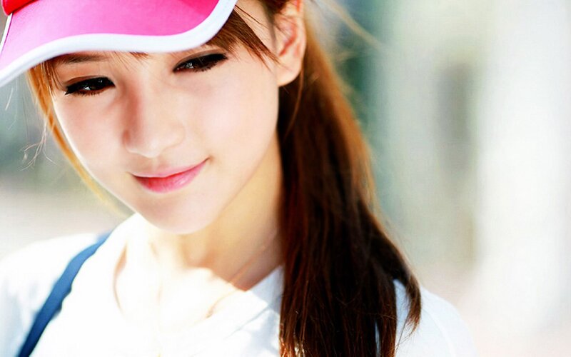 woman in pink visor smiling