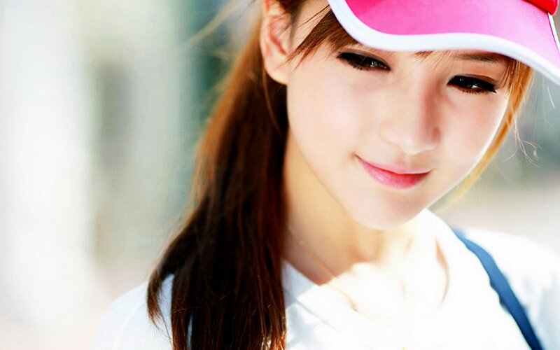 woman in pink visor smiling