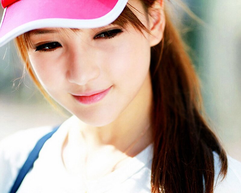 woman in pink visor smiling