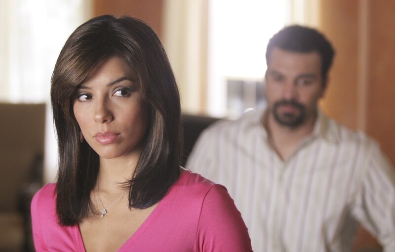 woman in pink with man behind