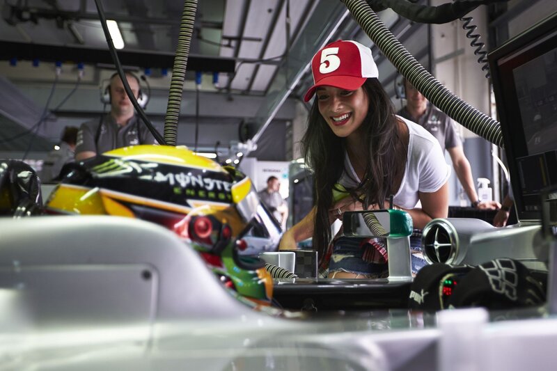 Woman in pit lane with race car