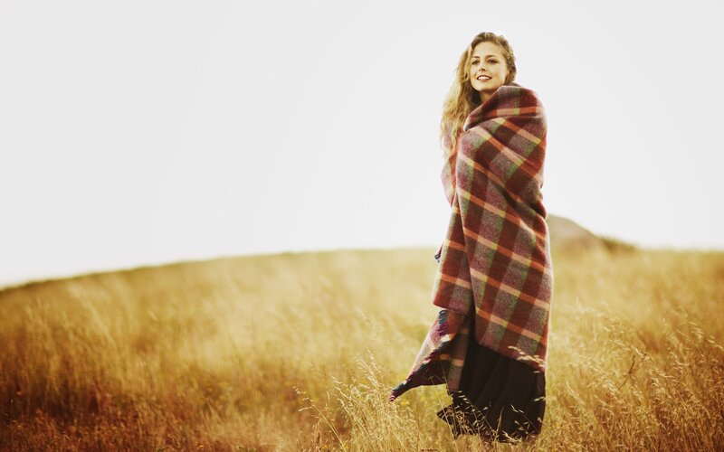 woman in plaid blanket field