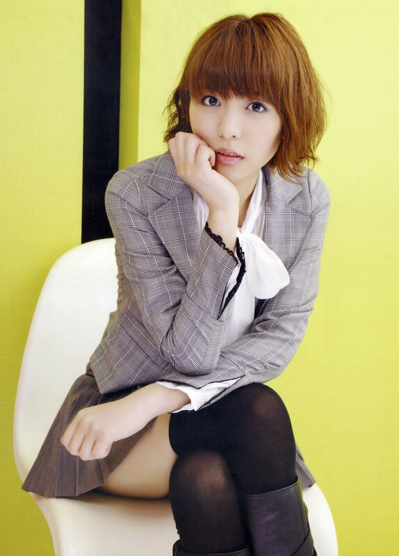 woman in plaid blazer sitting