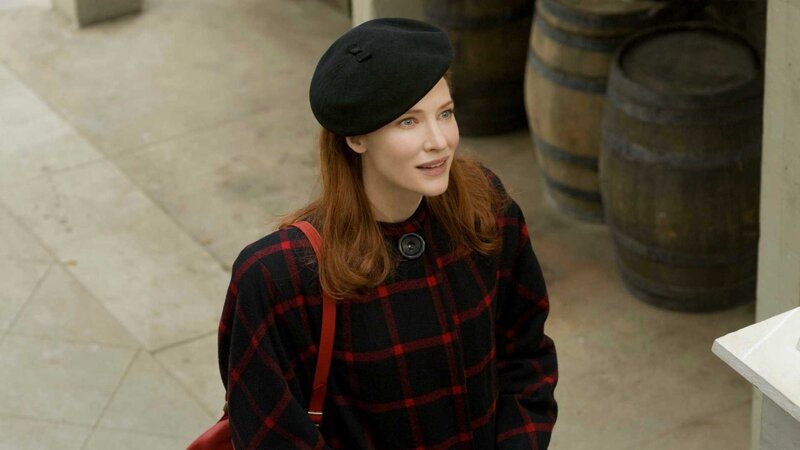 woman in plaid coat and beret