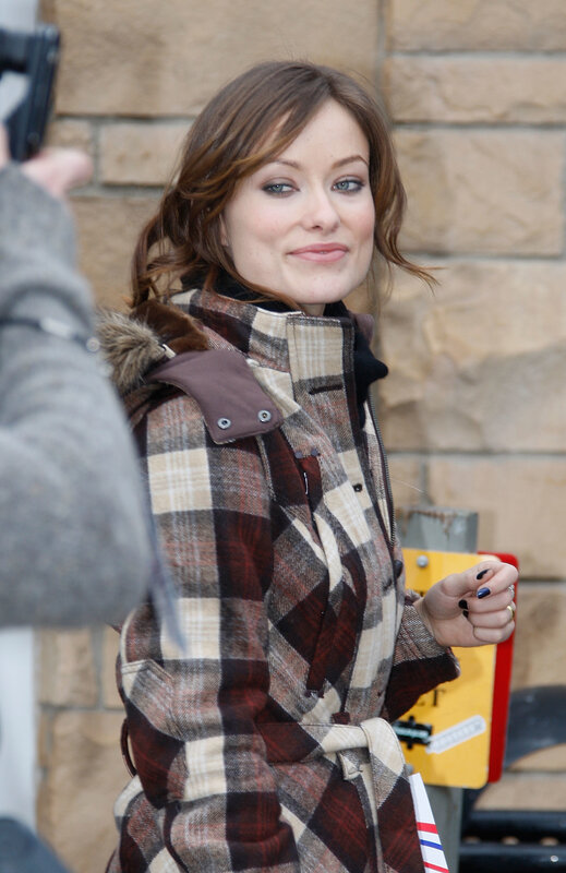 woman in plaid coat smiling