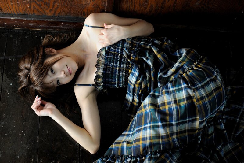 woman in plaid dress lying down
