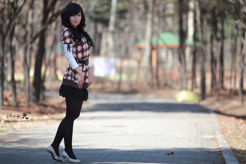 woman in plaid dress on path