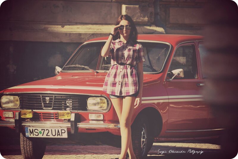woman in plaid dress with red car