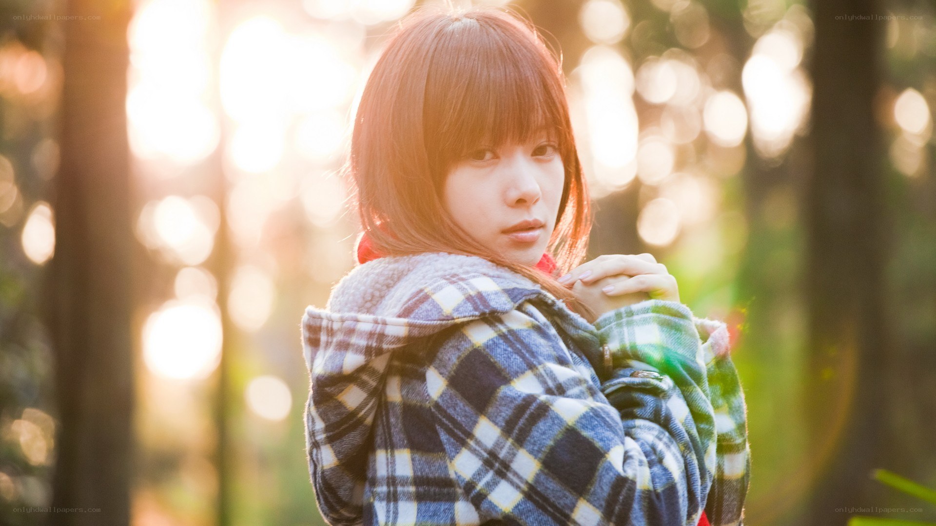 woman in plaid jacket at sunset