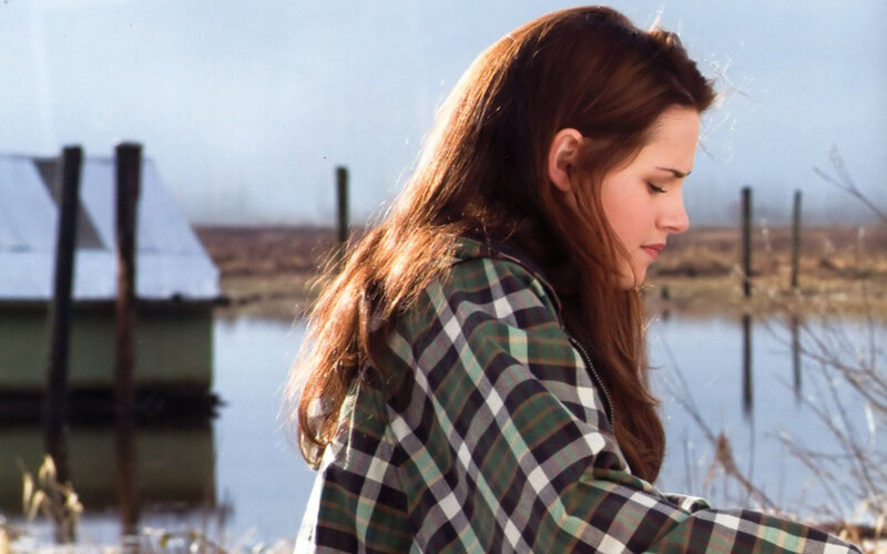 woman in plaid jacket by water