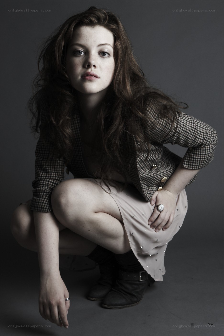 woman in plaid jacket crouching