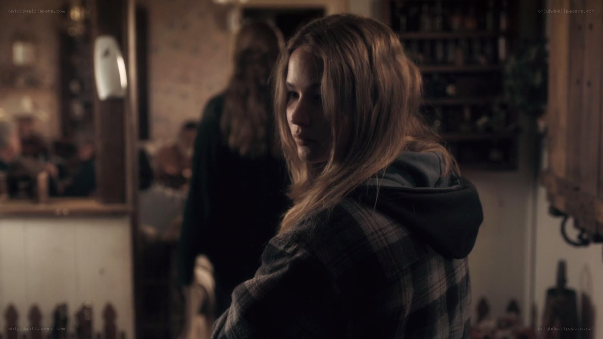 woman in plaid jacket looking back