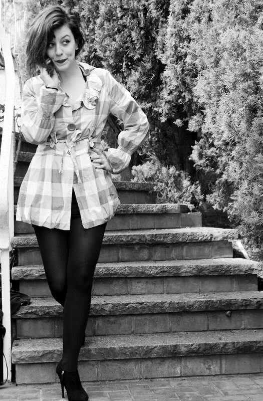 woman in plaid jacket on stairs