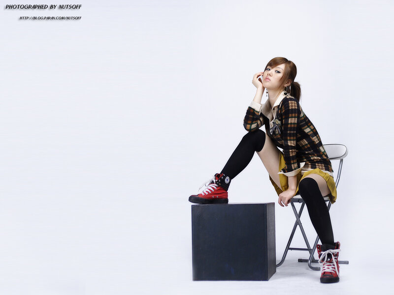 woman in plaid jacket sitting on chair