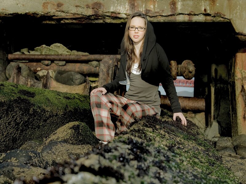 Woman in plaid pants on rocks