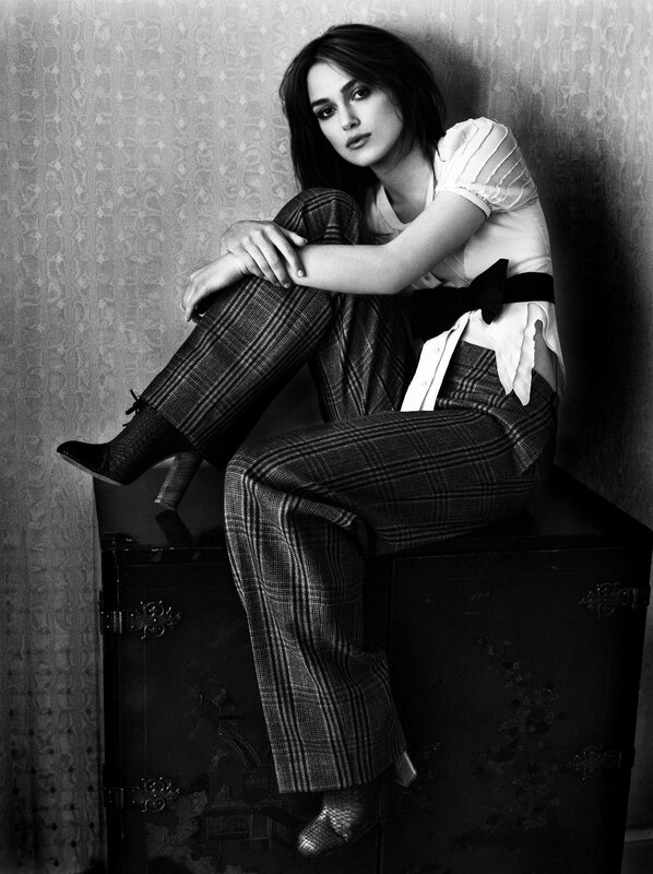 woman in plaid pants sitting
