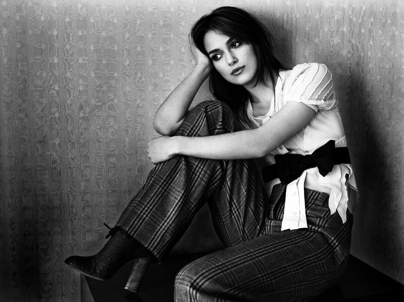 woman in plaid pants sitting