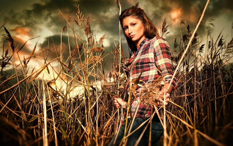 woman in plaid shirt among reeds