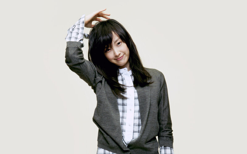 woman in plaid shirt and cardigan