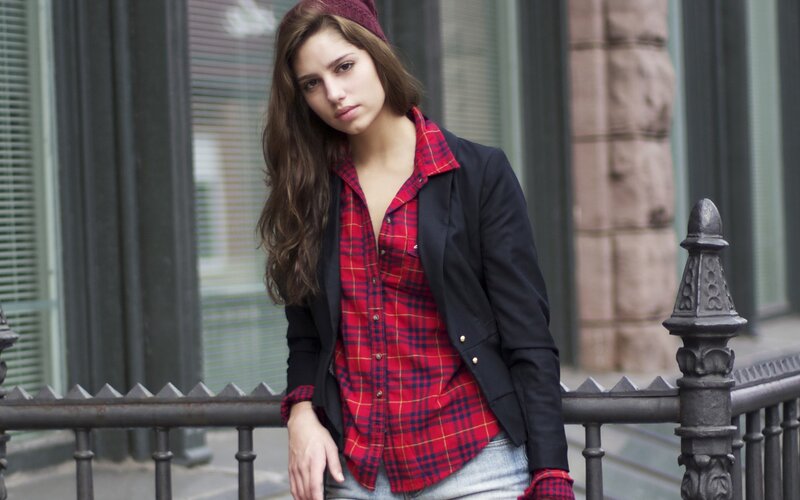 woman in plaid shirt and jacket