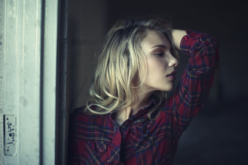 woman in plaid shirt by door