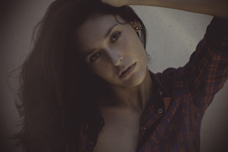 woman in plaid shirt looking at camera