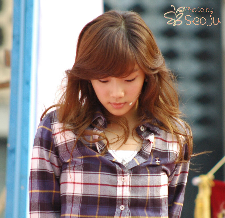 woman in plaid shirt looking down