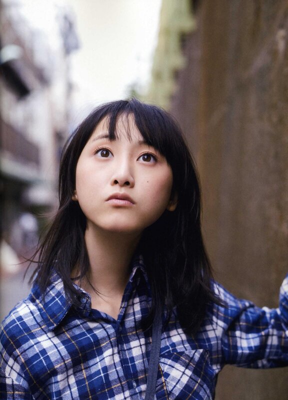 woman in plaid shirt looking up