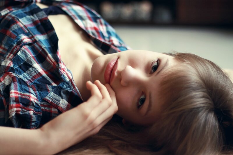 woman in plaid shirt lying down