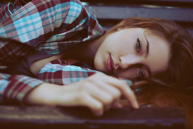 woman in plaid shirt lying down