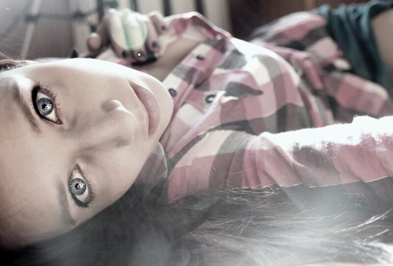 woman in plaid shirt lying down